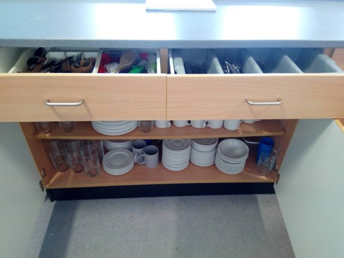 Cupboard in the kitchenette with a full set of cutlery and crockery