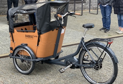A tricycle with a cargo area on top