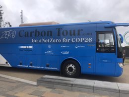 A blue bus with Zero Carbon Tour written on the side