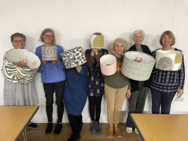 Participants at a lamp making event for Sew Positive