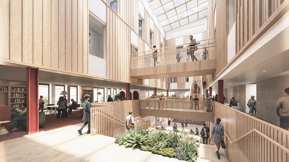 Artist's impression of the Northstowe Town Hub interior atrium, showing multiple levels connected by staircases and walkways, with seating, planting and people using shared communal spaces beneath a glazed roof.