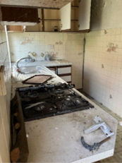 A kitchen with a dirty floor and a sink

AI-generated content may be incorrect.