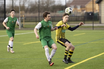 Official opening of the new Northstowe sports pavilion on Saturday 20th January 2024. Longstanton Football Club (yellow/black) play their first match on the new pitch against Litlington Football Club (green/white). LTR - Liam Welch and Adam Winter. Picture: davidjohnsonphotographic.co.uk