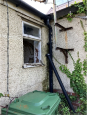 A window with a drain pipe

AI-generated content may be incorrect.